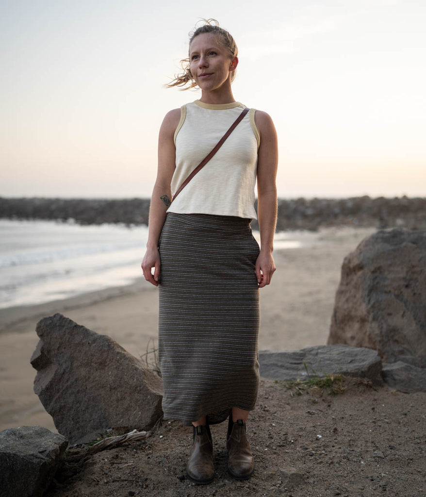 A woman outdoors wearing the Primary Stripe Skirt in petra stripe by Deso Supply Co. 1