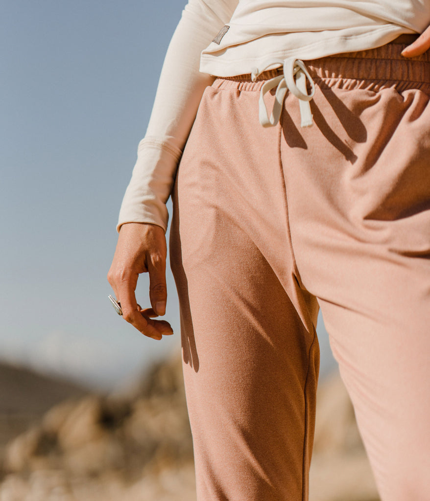 A close-up of a woman wearing the Madora Jogger in heather claypot color by Deso Supply Co. 1
