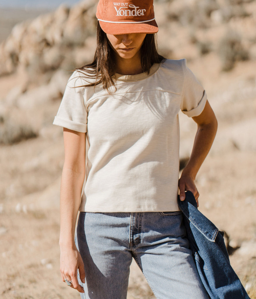 A woman wearing Kalmia Oversized Baggy Tee in beige color by Deso Supply Co.