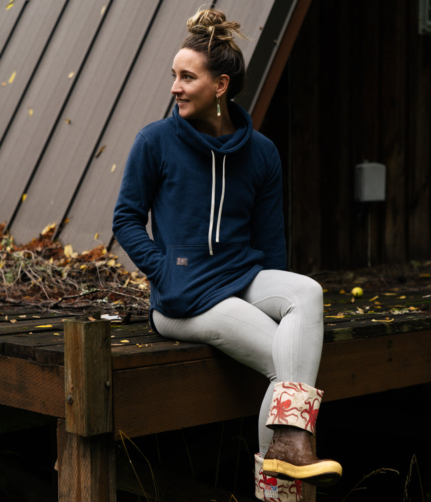 A woman wearing Tallac Pullover in insignia blue color by Deso Supply Co.