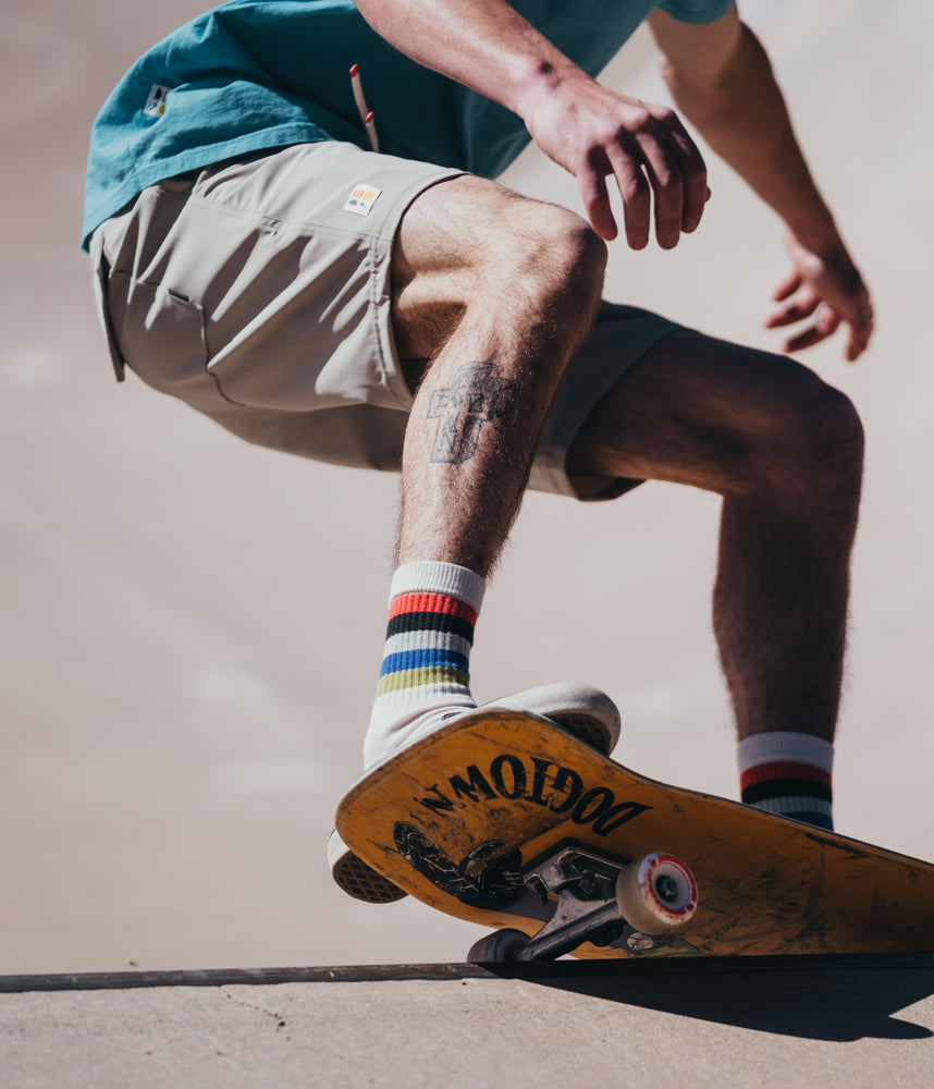 A man on a skateboard wearing Boca Board Shorts in mist color by Deso Supply Co. 2