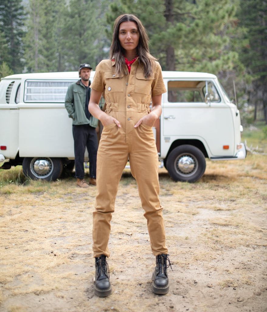 A woman wearing Homewood Coveralls in burlywood color by Deso Supply Co. 3
