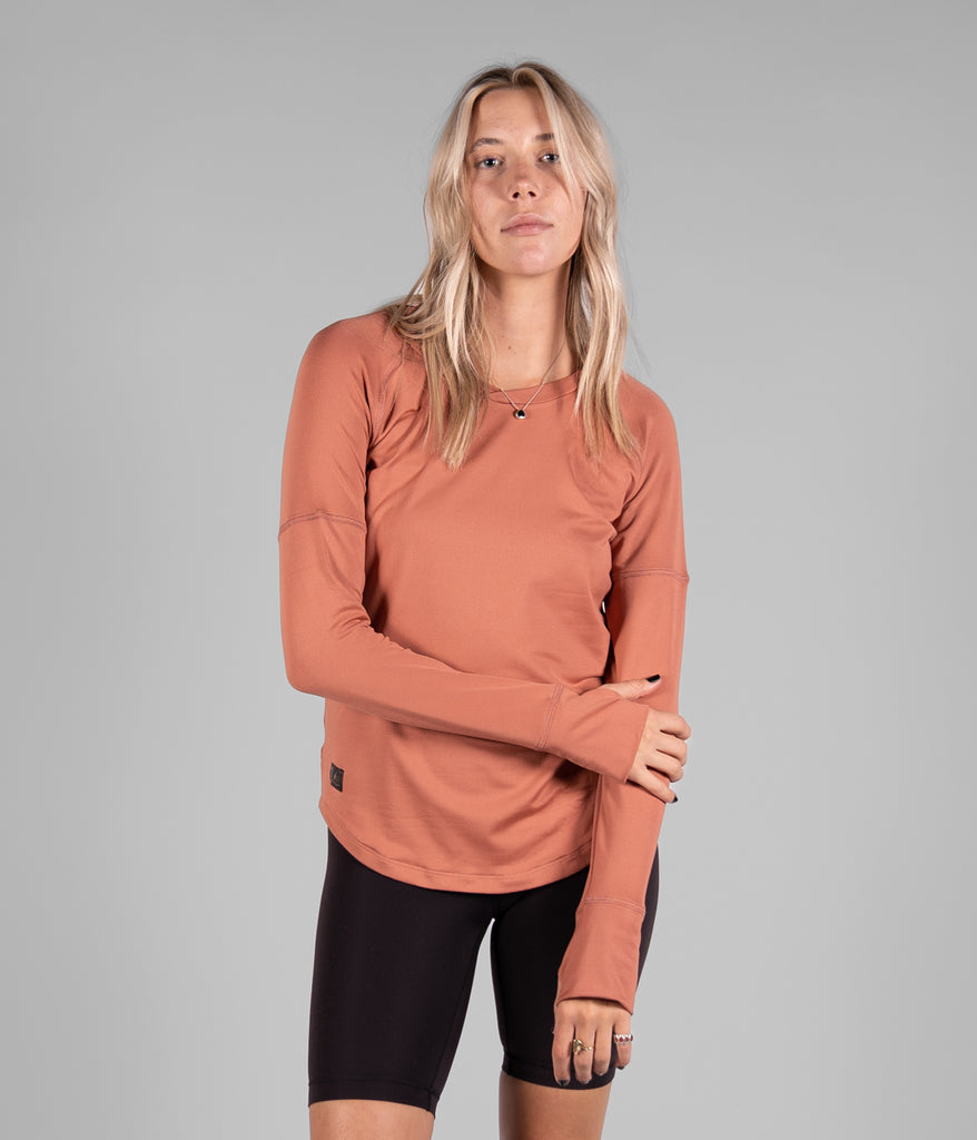 A woman wearing Maggie Long sleeve in claypot color by Deso Supply Co.
