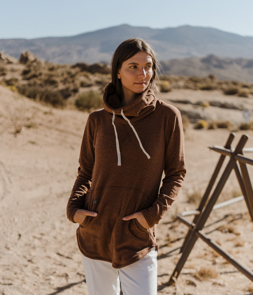 A woman wearing Tallac Pullover in rosewood color by Deso Supply Co.