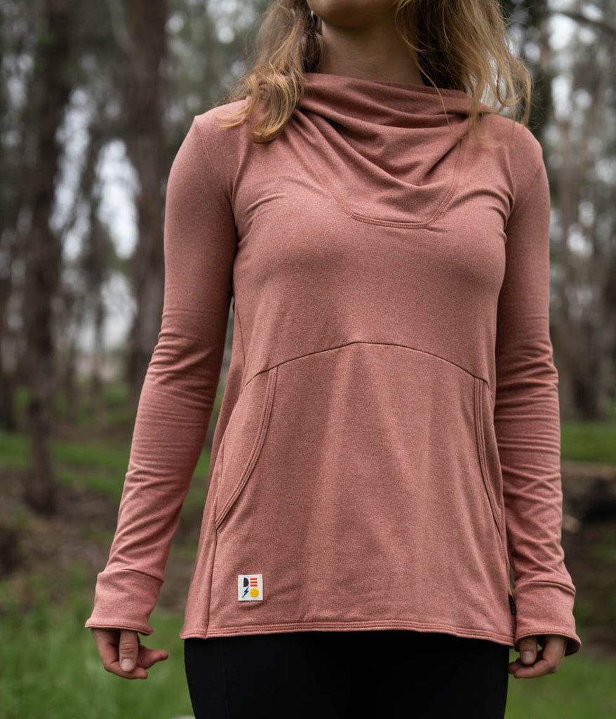 A woman wearing the Phipps Hoodie in claypot variant by Deso Supply Co.