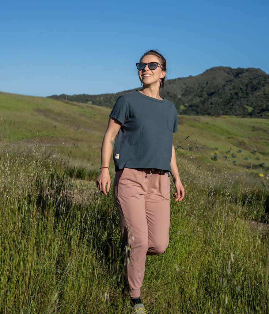 A woman outdoors wearing the Madora Jogger in heather slate color by Deso Supply Co. 1