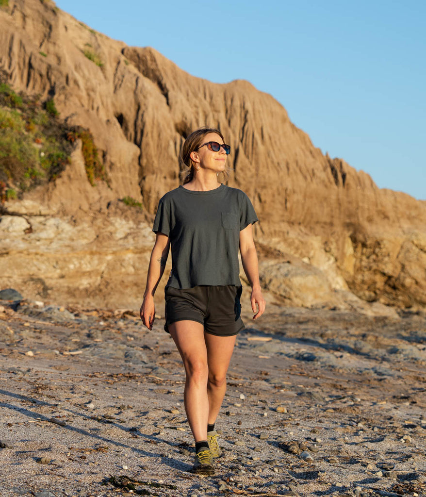 A woman outdoors wearing the Madora Short in forest black color by Deso Supply Co. 2