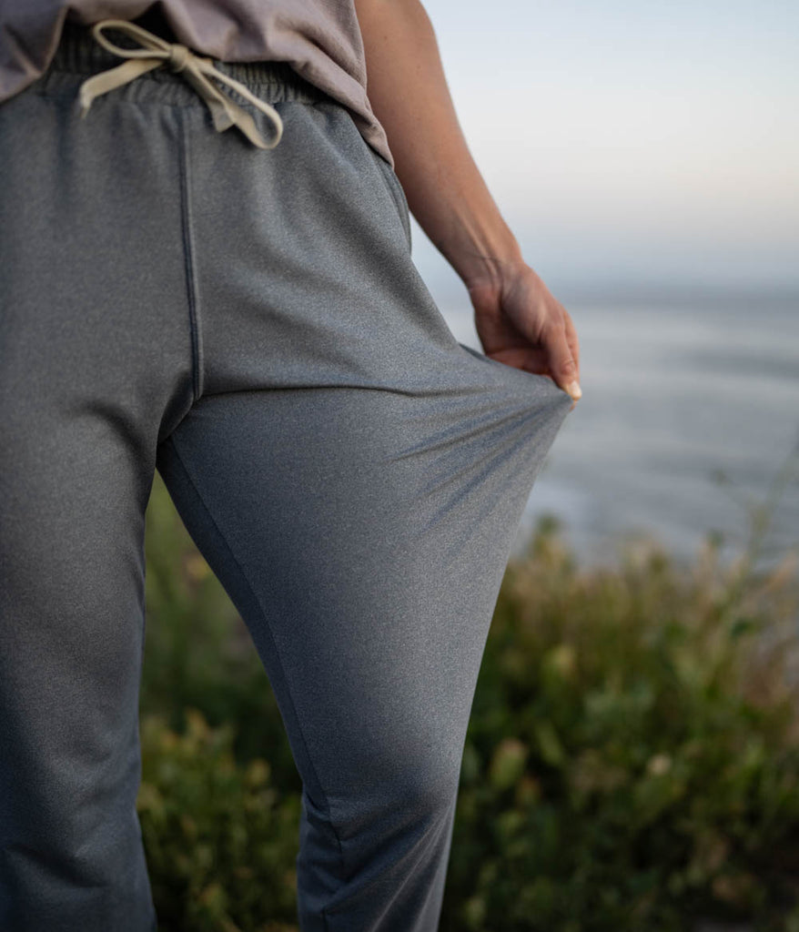 A close-up of a woman wearing the Madora Jogger in heather slate color by Deso Supply Co. 1