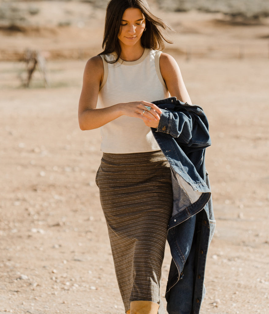 A woman outdoors wearing the Primary Stripe Skirt in petra stripe by Deso Supply Co.