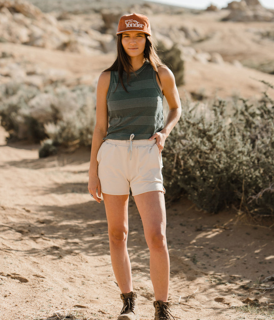 A woman wearing Madora Short in white sand color by Deso Supply Co.