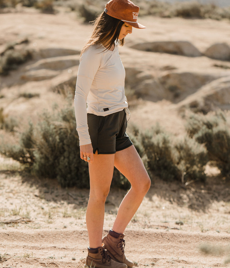 A woman outdoors wearing the Madora Short in forest black color by Deso Supply Co. 1