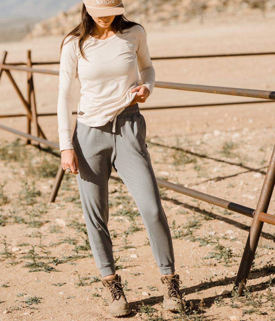 A woman wearing Madora Jogger in heather slate color by Deso Supply Co.