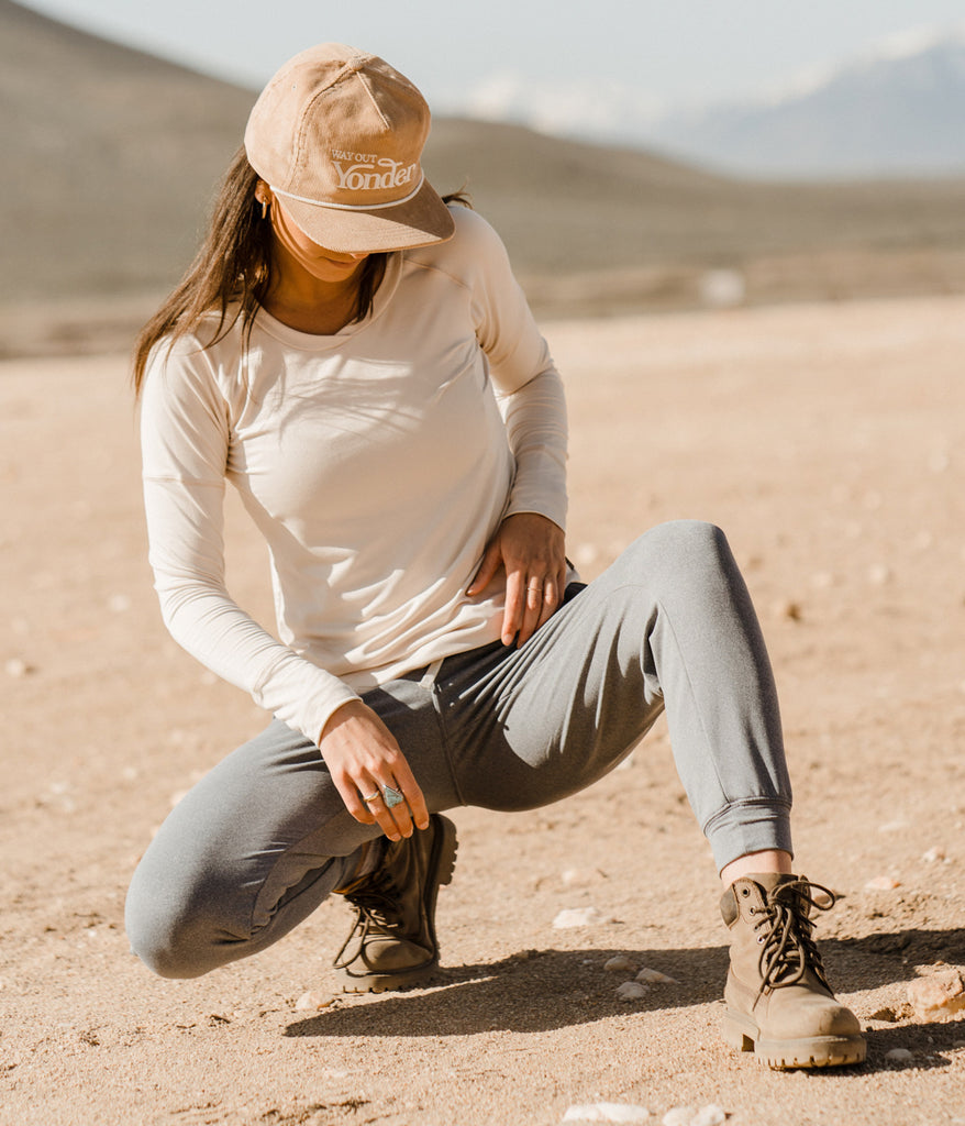 A woman outdoors wearing the Madora Jogger in heather slate color by Deso Supply Co.