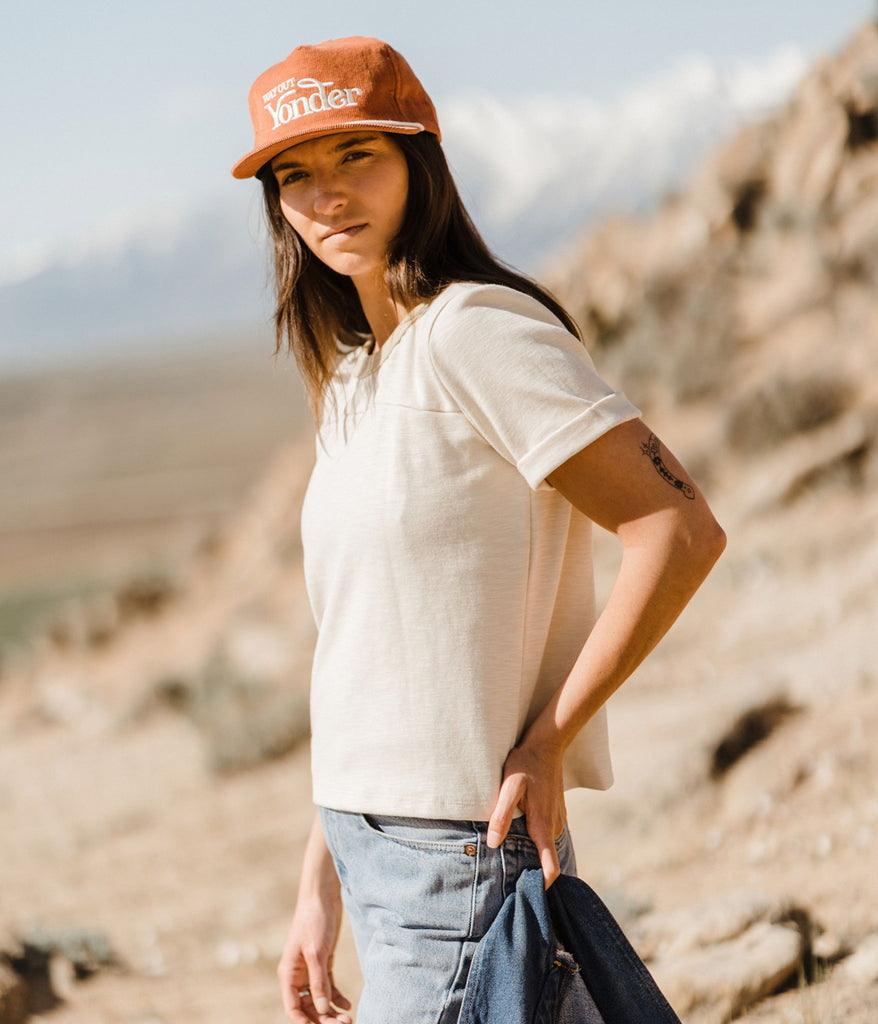 A woman wearing Kalmia Oversized Baggy Tee in beige color by Deso Supply Co. 1