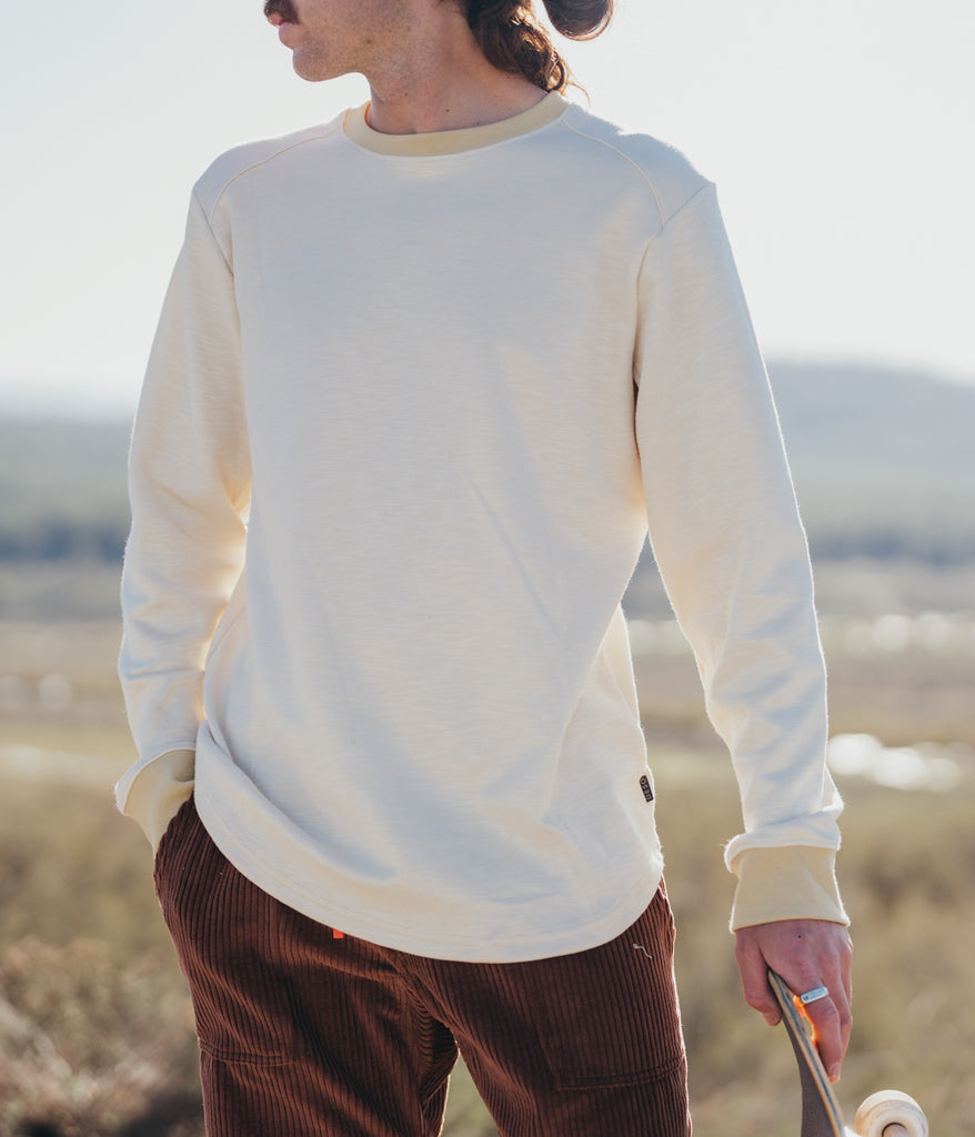 A man wearing the Primary Slub long sleeve in beige color by Deso Supply Co.