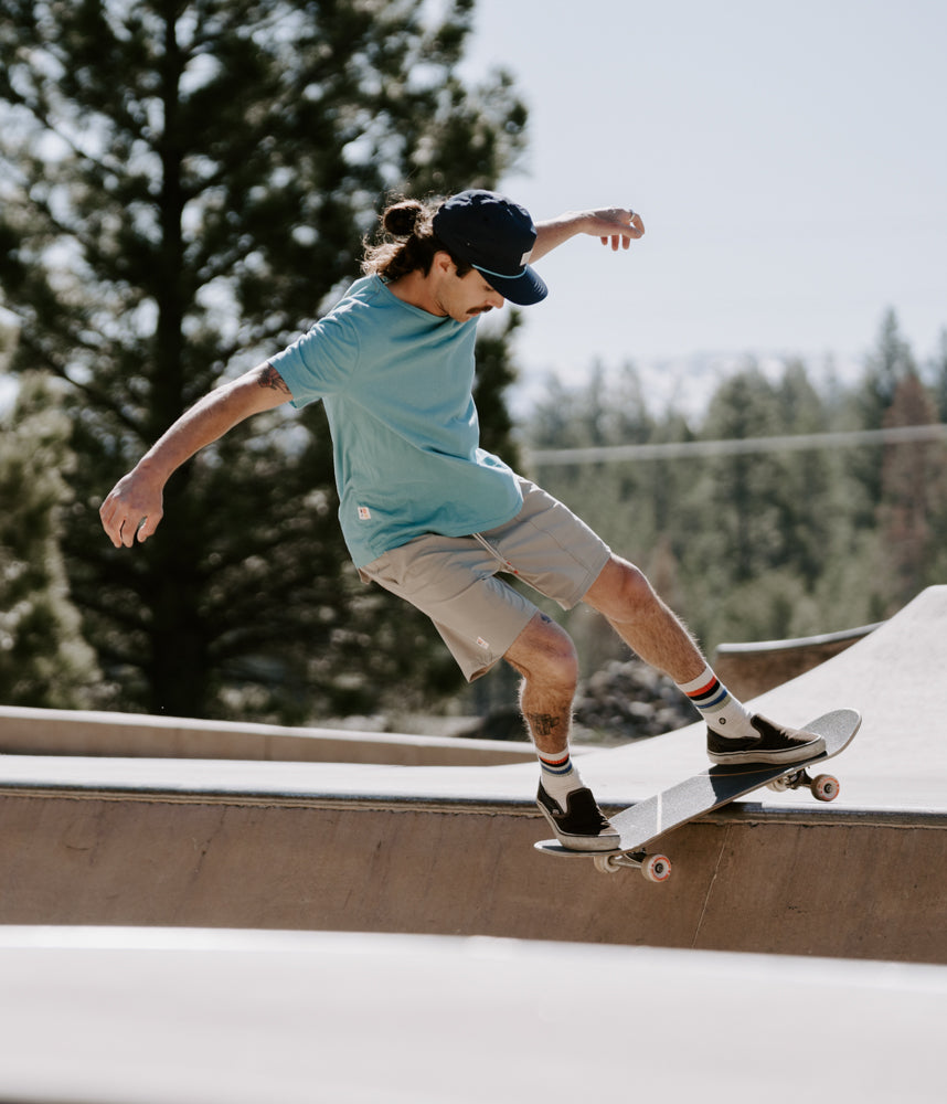 A man on a skateboard wearing Boca Board Shorts in mist color by Deso Supply Co. 1