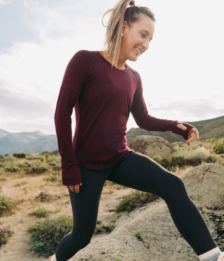 A woman outdoors wearing Shirley Long Sleeve in burgundy color by Deso Supply Co.