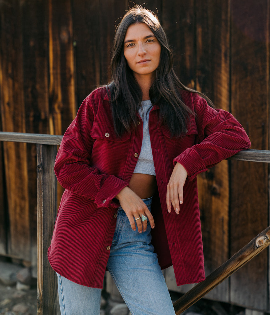 A woman wearing Valhalla Cord Shirt in cherry color by Deso Supply Co.
