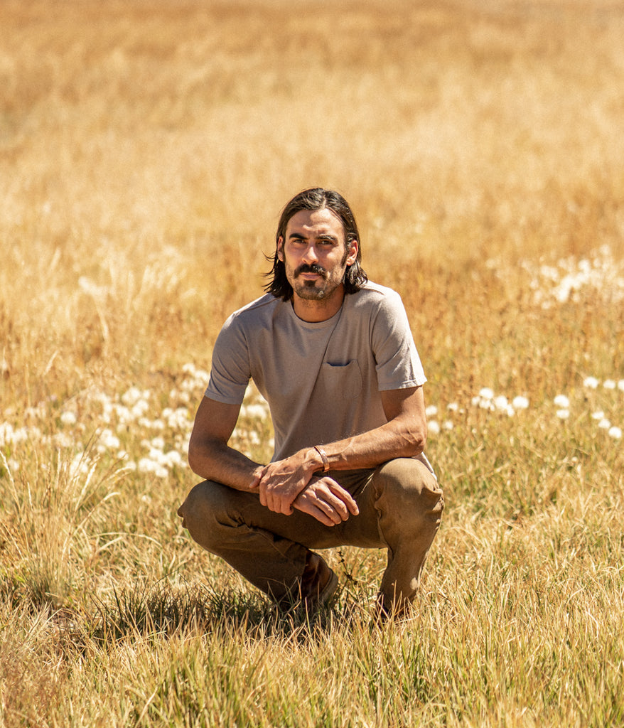 A man outdoors wearing Men's Primary Pocket Tee in lavender color