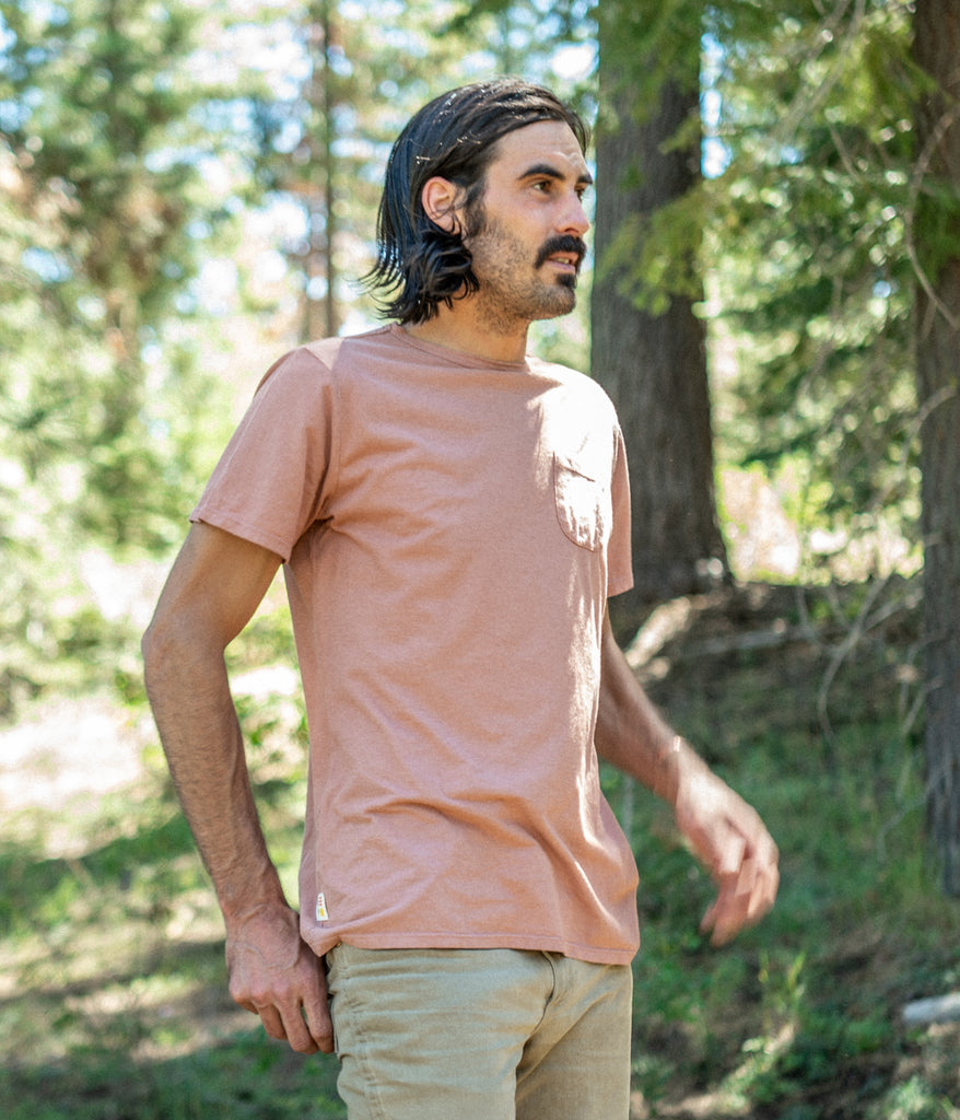A man wearing a Men's Primary Pocket Tee in lavender color by Deso Supply Co. 2