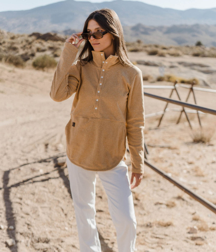 A woman wearing Genevieve Snap Pullover 8s in desert camel by Deso Supply Co.