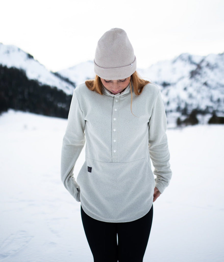 A woman wearing Genevieve Snap Pullover 8s in winter white color by Deso Supply Co.