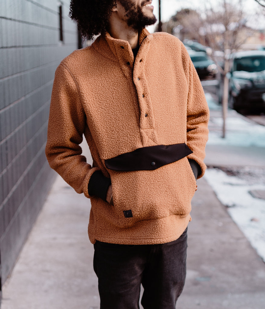 A man wearing Ralston Snap Pullover in maple color by Deso Supply Co. 1