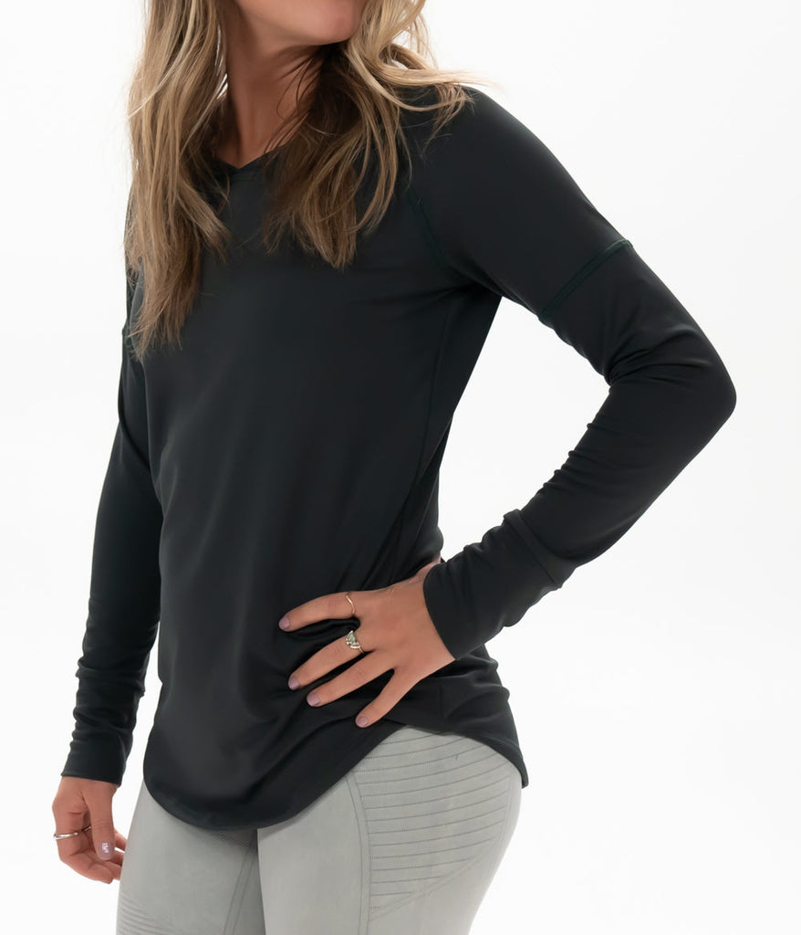 A close-up of a woman wearing Maggie Long sleeve in forest black color by Deso Supply Co.